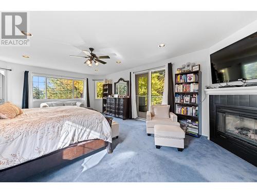 3257 Juniper Drive, Naramata, BC - Indoor Photo Showing Bedroom With Fireplace