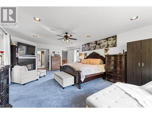 3257 Juniper Drive, Naramata, BC - Indoor Photo Showing Bedroom With Fireplace