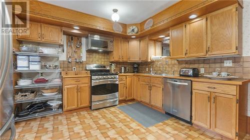 Kitchen featuring decorative backsplash, appliances with stainless steel finishes, and sink - 246 Light Street, Woodstock, ON - Indoor Photo Showing Kitchen