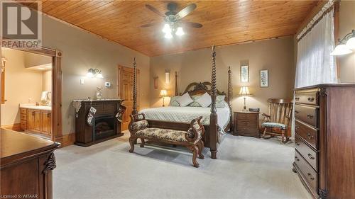 Carpeted bedroom featuring ensuite bath, ceiling fan, and wooden ceiling - 246 Light Street, Woodstock, ON - Indoor Photo Showing Bedroom