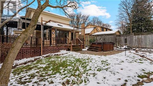 Snow covered rear of property featuring a deck and a hot tub - 246 Light Street, Woodstock, ON - Outdoor With Deck Patio Veranda