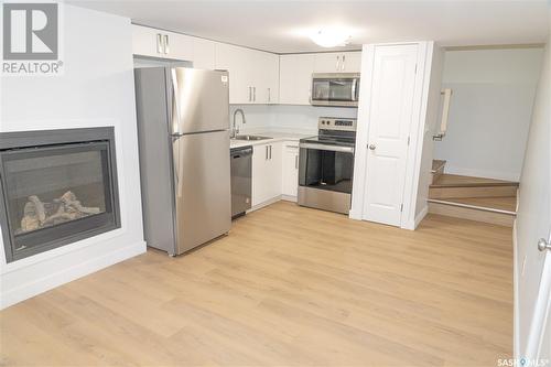 210 Sharma Lane, Saskatoon, SK - Indoor Photo Showing Kitchen With Fireplace With Stainless Steel Kitchen