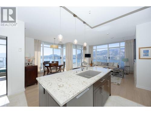 open concept kitchen-living-dining area with expansive lake, valley and mountain views. - 1075 Sunset Drive Unit# 2604, Kelowna, BC - Indoor Photo Showing Kitchen With Upgraded Kitchen