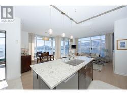 open concept kitchen-living-dining area with expansive lake, valley and mountain views. - 