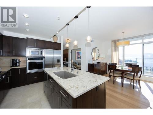 open concept kitchen-living-dining area with expansive lake, valley and mountain views. - 1075 Sunset Drive Unit# 2604, Kelowna, BC - Indoor Photo Showing Kitchen With Upgraded Kitchen