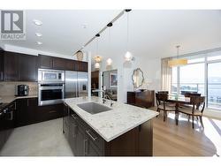 open concept kitchen-living-dining area with expansive lake, valley and mountain views. - 