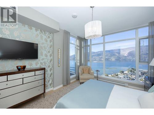 Primary with stunning lake, valley and mountain views. - 1075 Sunset Drive Unit# 2604, Kelowna, BC - Indoor Photo Showing Bedroom