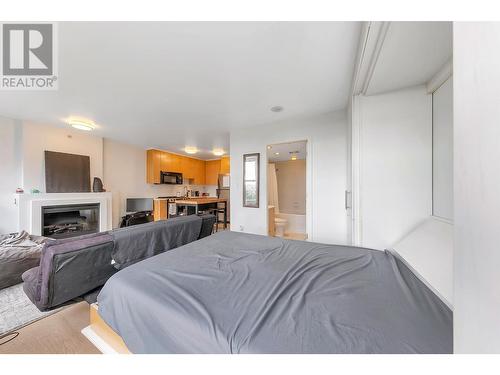 704 989 Beatty Street, Vancouver, BC - Indoor Photo Showing Bedroom With Fireplace