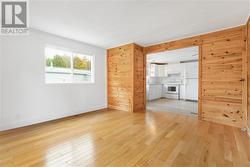 Hardwood floors and a wood feature wall gives it warmth - 