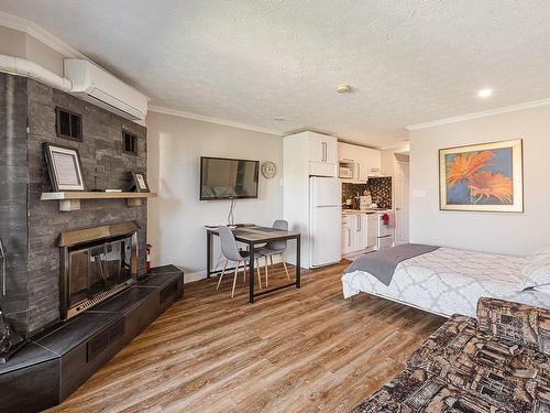 Salon - D-203-261 Rue Merry S., Magog, QC - Indoor Photo Showing Bedroom With Fireplace