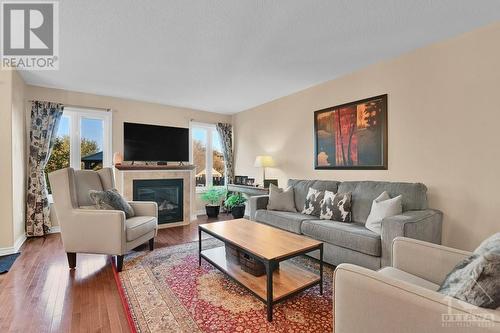 Living Room with Gas Fireplace - 1843 Arrowgrass Way, Ottawa, ON - Indoor Photo Showing Living Room With Fireplace