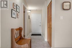 Hallway featuring light tile patterned flooring - 