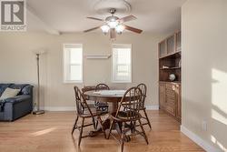 Dining room with light wood-type flooring and ceiling fan - 