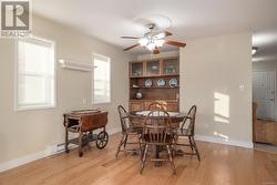 Dining space with light hardwood / wood-style flooring and ceiling fan - 