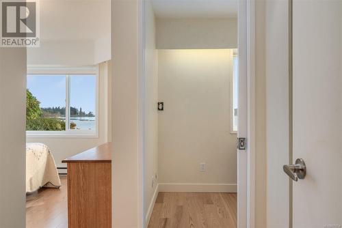 Hall featuring a baseboard radiator and light hardwood / wood-style flooring - 101 145 Newcastle Ave, Nanaimo, BC - Indoor Photo Showing Other Room