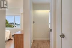 Hall featuring a baseboard radiator and light hardwood / wood-style flooring - 