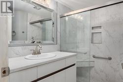 Bathroom featuring vanity and a shower with door - 