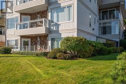 Rear view of house with a balcony and a yard - 