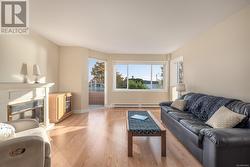 Living room featuring light hardwood / wood-style floors and a baseboard radiator - 