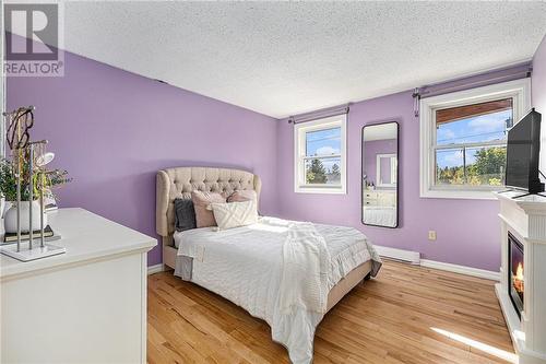 2nd Bedroom. The front windows allow so much natural light with stunning views of the timber frame porch. - 126 Code Road, Perth, ON - Indoor Photo Showing Bedroom