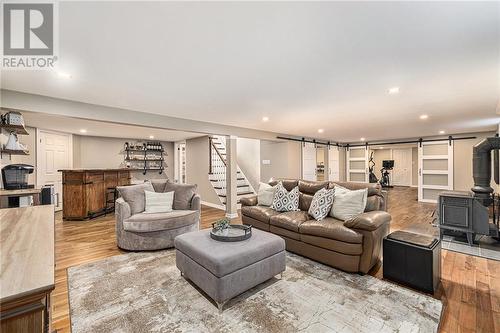 Stunning lower level feat. HARD WOOD FLOORS throughout- something you don't see often! This is the ultimate space to cozy up and watch a movie with the family! - 126 Code Road, Perth, ON - Indoor Photo Showing Living Room