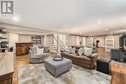 Stunning lower level feat. HARD WOOD FLOORS throughout- something you don't see often! This is the ultimate space to cozy up and watch a movie with the family! - 