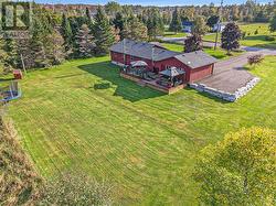 Rear aerial view. Do not miss the gorgeous armour stone wall and steps. Brand new paved driveway(2024). - 