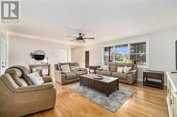 Main floor living room. Large front window and sweet garden door leading to the front porch. The most perfect spot to sit and drink morning coffee. - 