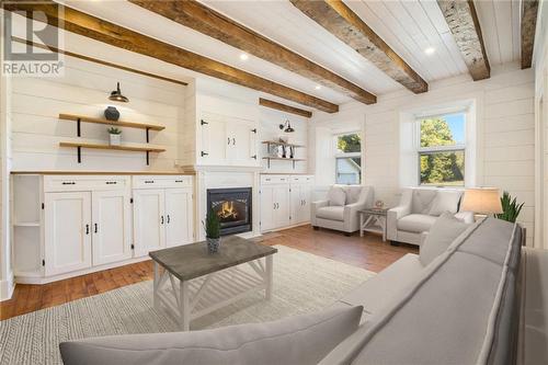 Living room digitally staged main house - 538 Clear Lake Road, Elgin, ON - Indoor Photo Showing Living Room With Fireplace