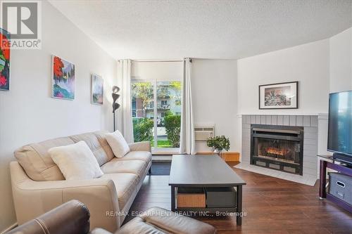 312 - 1450 Glen Abbey Gate, Oakville, ON - Indoor Photo Showing Living Room With Fireplace