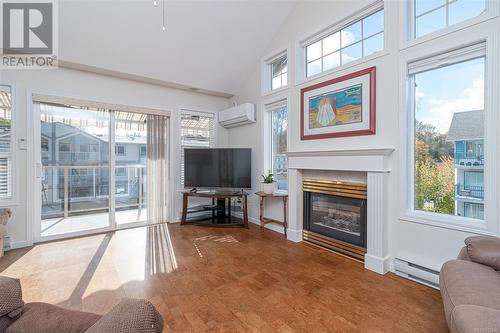 Living room with NG Fireplace and vaulted ceiling - 301 245 First St, Duncan, BC - Indoor Photo Showing Living Room With Fireplace