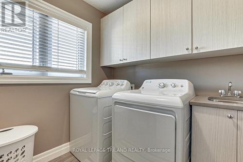 Upper level gas dryer & washer with sink & cabinet - 185 Spencer Avenue, Lucan Biddulph (Lucan), ON - Indoor Photo Showing Laundry Room