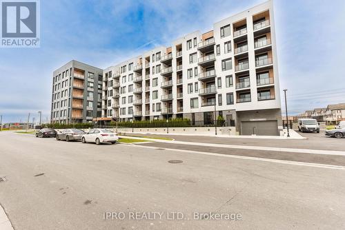 407 - 1440 Clarriage Court, Milton, ON - Outdoor With Balcony With Facade