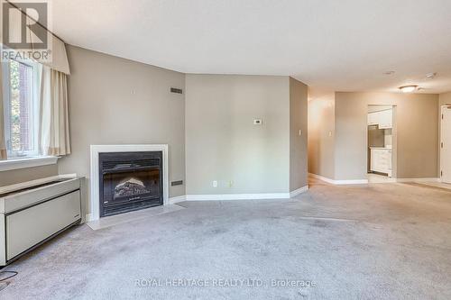 217 - 189 Lake Driveway W, Ajax, ON - Indoor Photo Showing Living Room With Fireplace