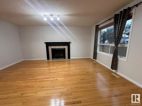 1569 37A Av Nw, Edmonton, AB - Indoor Photo Showing Other Room With Fireplace