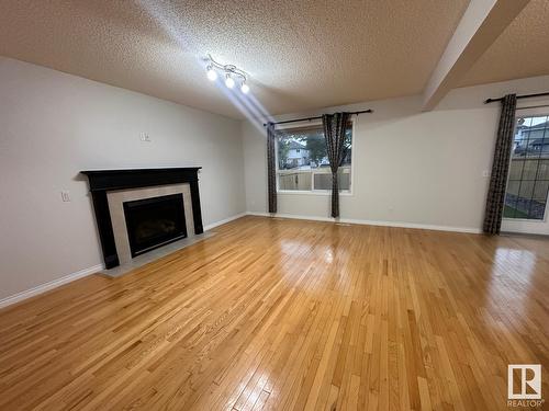 1569 37A Av Nw, Edmonton, AB - Indoor Photo Showing Living Room With Fireplace