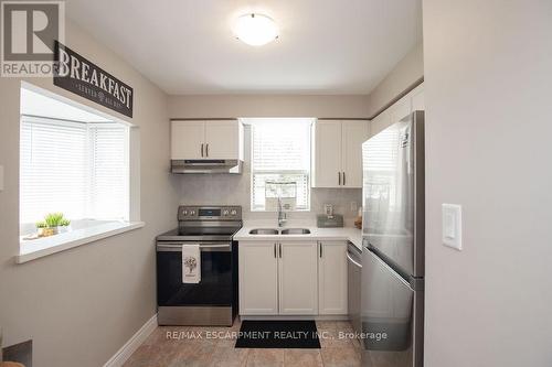 101 - 1270 Maple Crossing Boulevard, Burlington, ON - Indoor Photo Showing Kitchen With Stainless Steel Kitchen With Double Sink