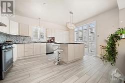 Modern kitchen with extended cabinetry and California shutters. - 