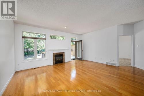 Living & Dining area with walk out - 60 - 44 Edgevalley Road, London, ON - Indoor Photo Showing Living Room With Fireplace