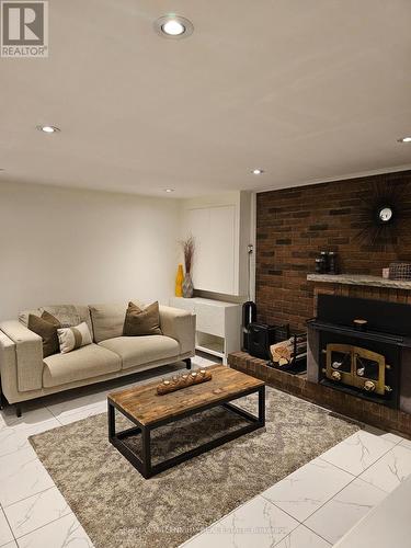 65 Vange Crescent, Toronto (Mount Olive-Silverstone-Jamestown), ON - Indoor Photo Showing Living Room With Fireplace