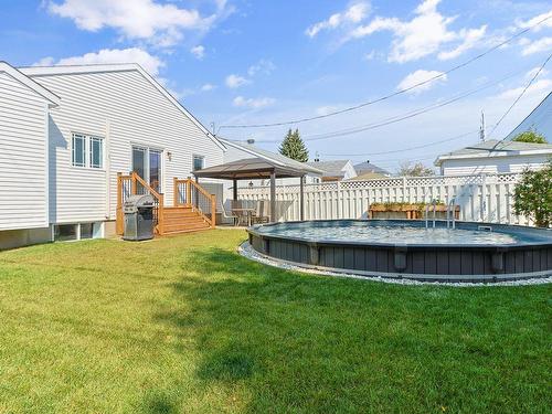 Back facade - 220 Rue Berger, Saint-Constant, QC - Outdoor With Above Ground Pool