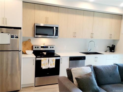 107-6544 Metral Dr, Nanaimo, BC - Indoor Photo Showing Kitchen With Stainless Steel Kitchen With Double Sink