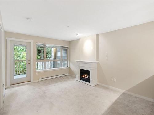 202-5670 Edgewater Lane, Nanaimo, BC - Indoor Photo Showing Other Room With Fireplace