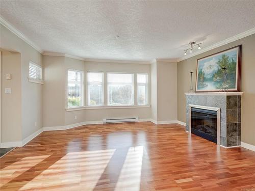 111-4480 Chatterton Way, Saanich, BC - Indoor Photo Showing Living Room With Fireplace