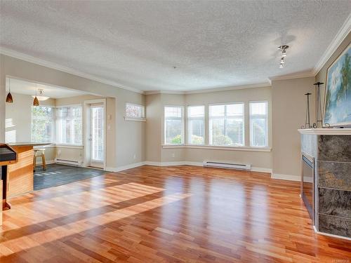 111-4480 Chatterton Way, Saanich, BC - Indoor Photo Showing Other Room With Fireplace