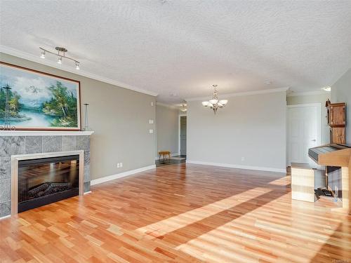 111-4480 Chatterton Way, Saanich, BC - Indoor Photo Showing Living Room With Fireplace