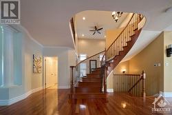 Curved hardwood staircase with wrought iron spindles - 