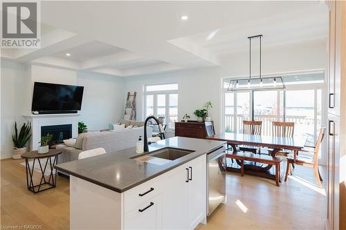 Gorgeous quartz countertop island - 403 Northport Drive, Port Elgin, ON - Indoor Photo Showing Other Room With Fireplace