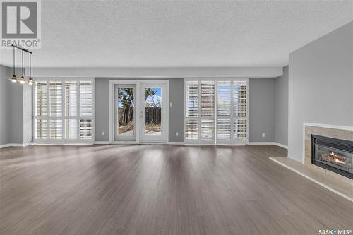 1024 Gryphons Walk, Regina, SK - Indoor Photo Showing Living Room With Fireplace