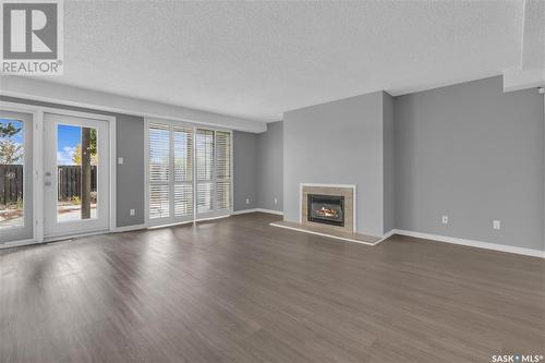 1024 Gryphons Walk, Regina, SK - Indoor Photo Showing Living Room With Fireplace